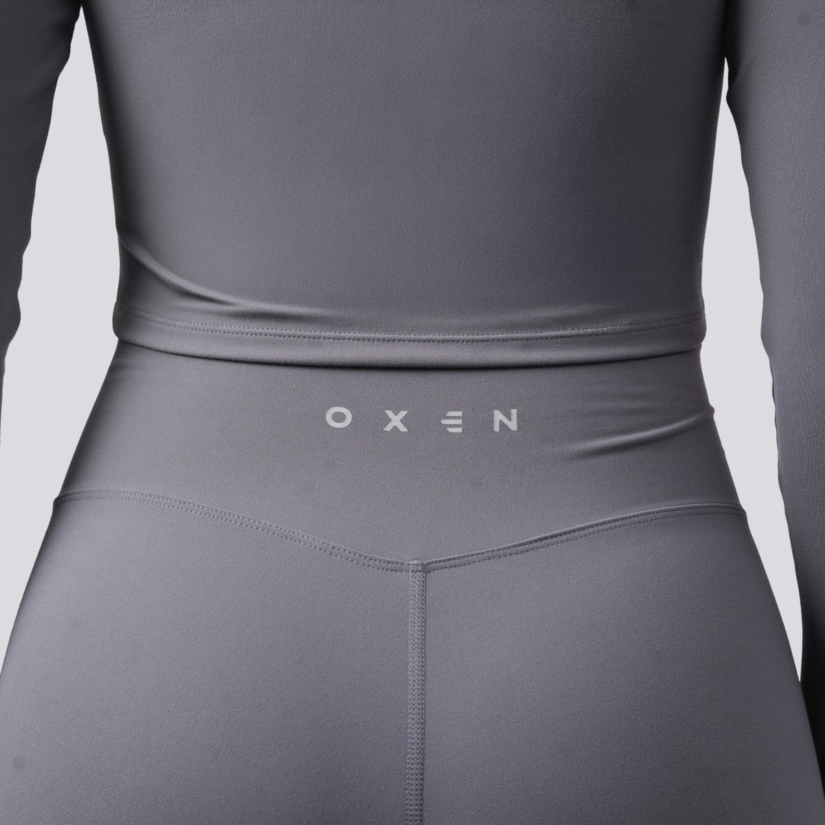 Gray athletic outfit with 'OXEN' branding on a light gray background