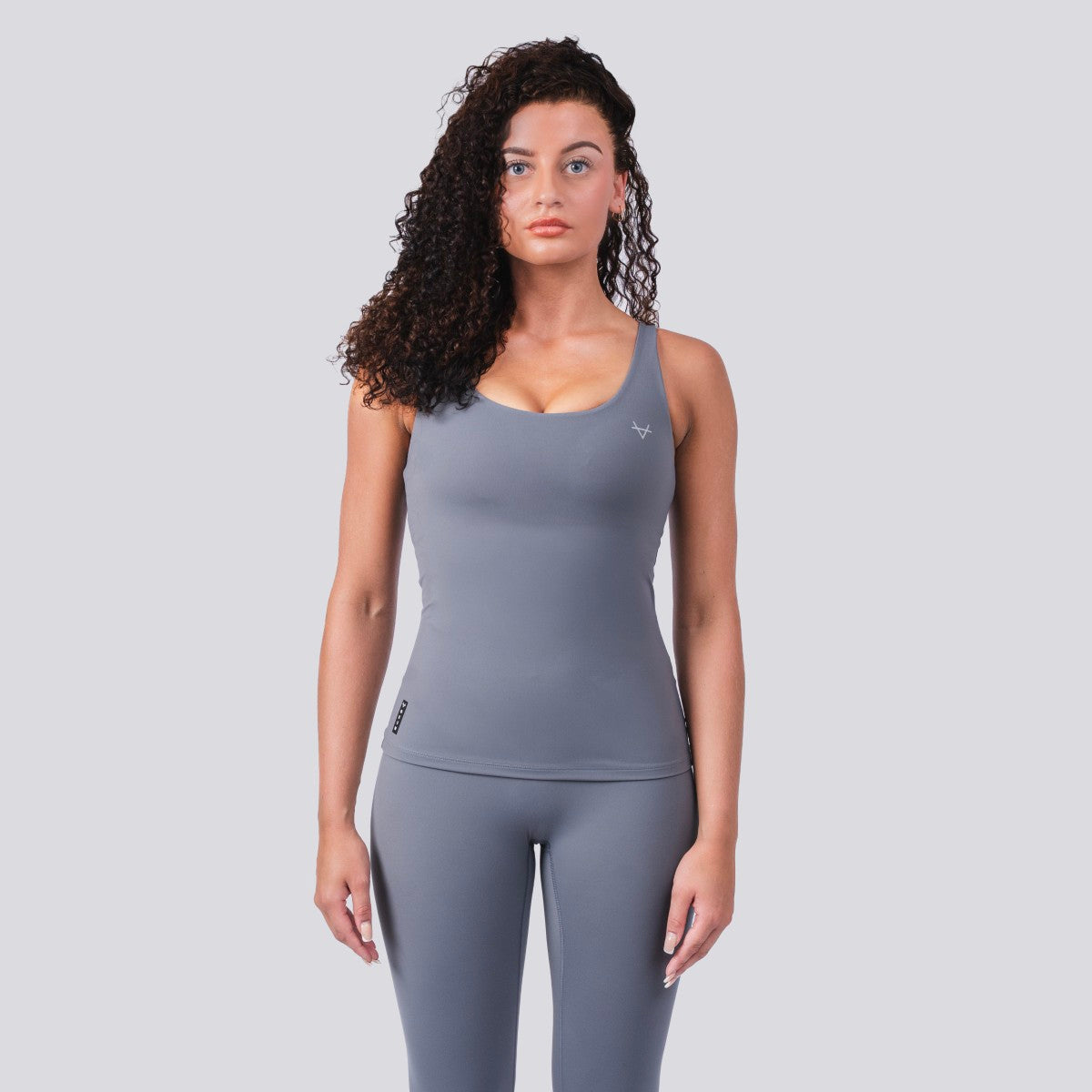 Model wearing Oxen Women’s Endure Sculpt Tank in Fossil grey, front view.