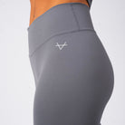 Gray leggings with a logo on a white background