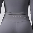 Gray athletic outfit with 'OXEN' branding on a light gray background