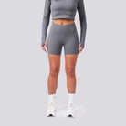 Person wearing gray athletic outfit on a light gray background