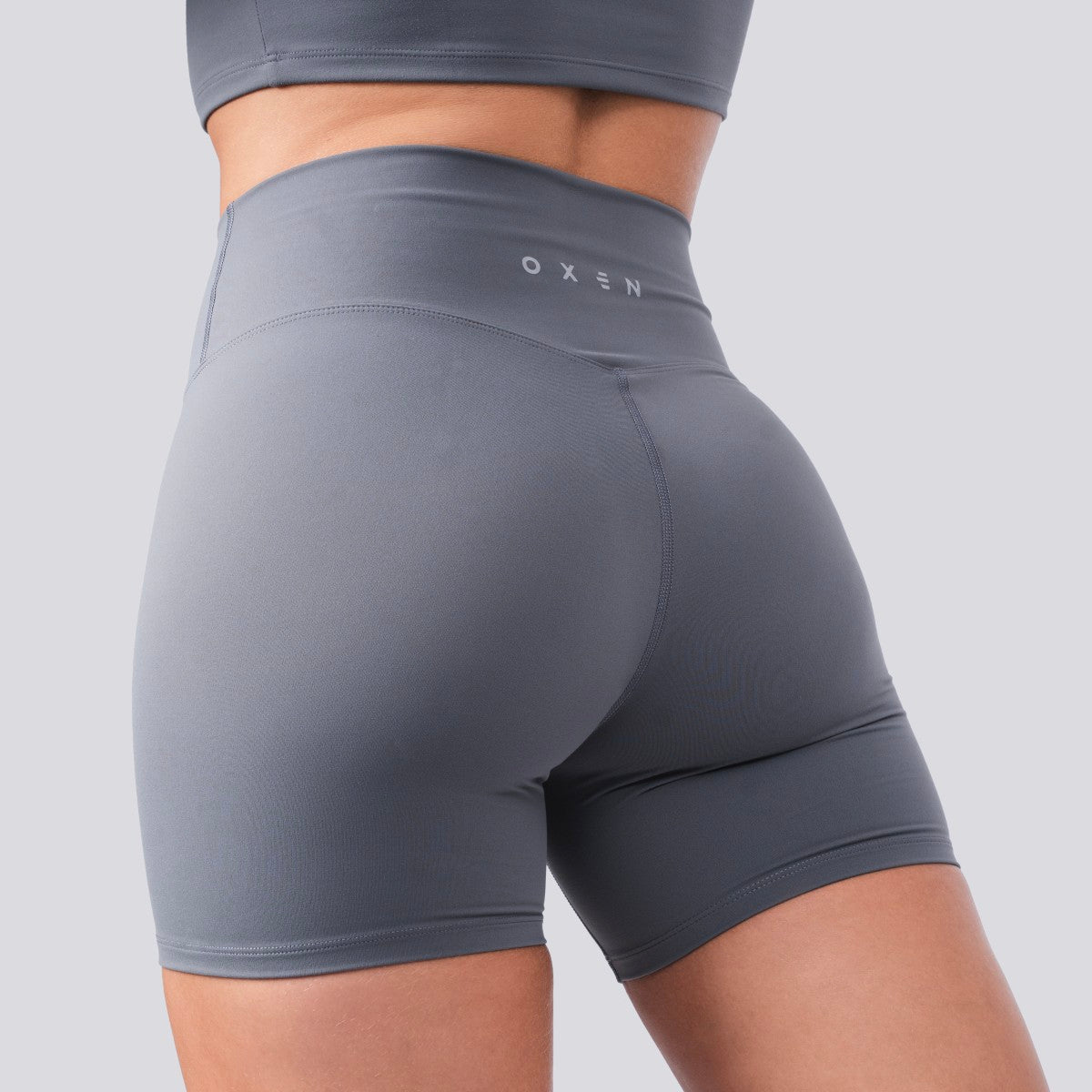 Gray athletic shorts with 'OXEN' branding on a light gray background