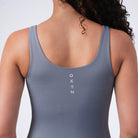 Back of Oxen Women’s Endure Sculpt Tank in Fossil grey showing vertical Oxen logo.