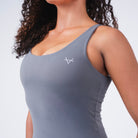 Close-up of chest logo detail on Oxen Women’s Endure Sculpt Tank in Fossil grey.